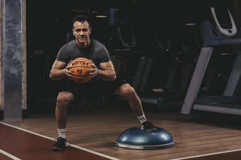 Balance work on a BOSU with a Basket Bullet medicine ball